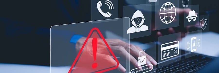 a man typing on a computer sees a security alert
