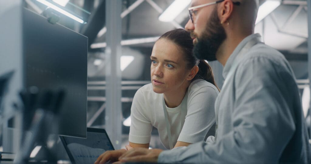 Two IT support reviewing the system.